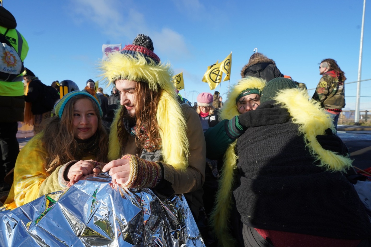 Environmental protesters dress as canaries to block entrance to mine 